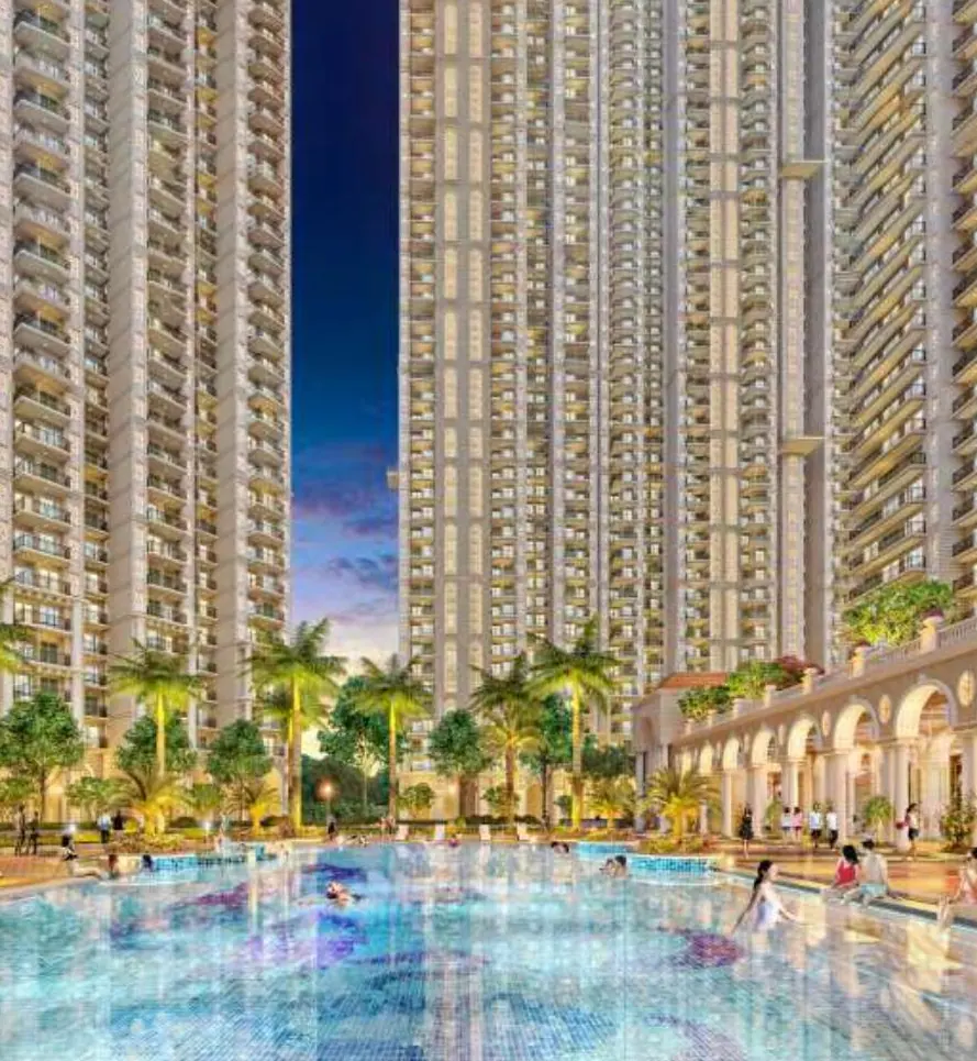 Prateek Grand Begonia swimming pool lit at dusk with towers behind